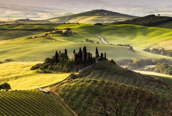 Tuscany Toscana landscape with traditional farm house, hills and